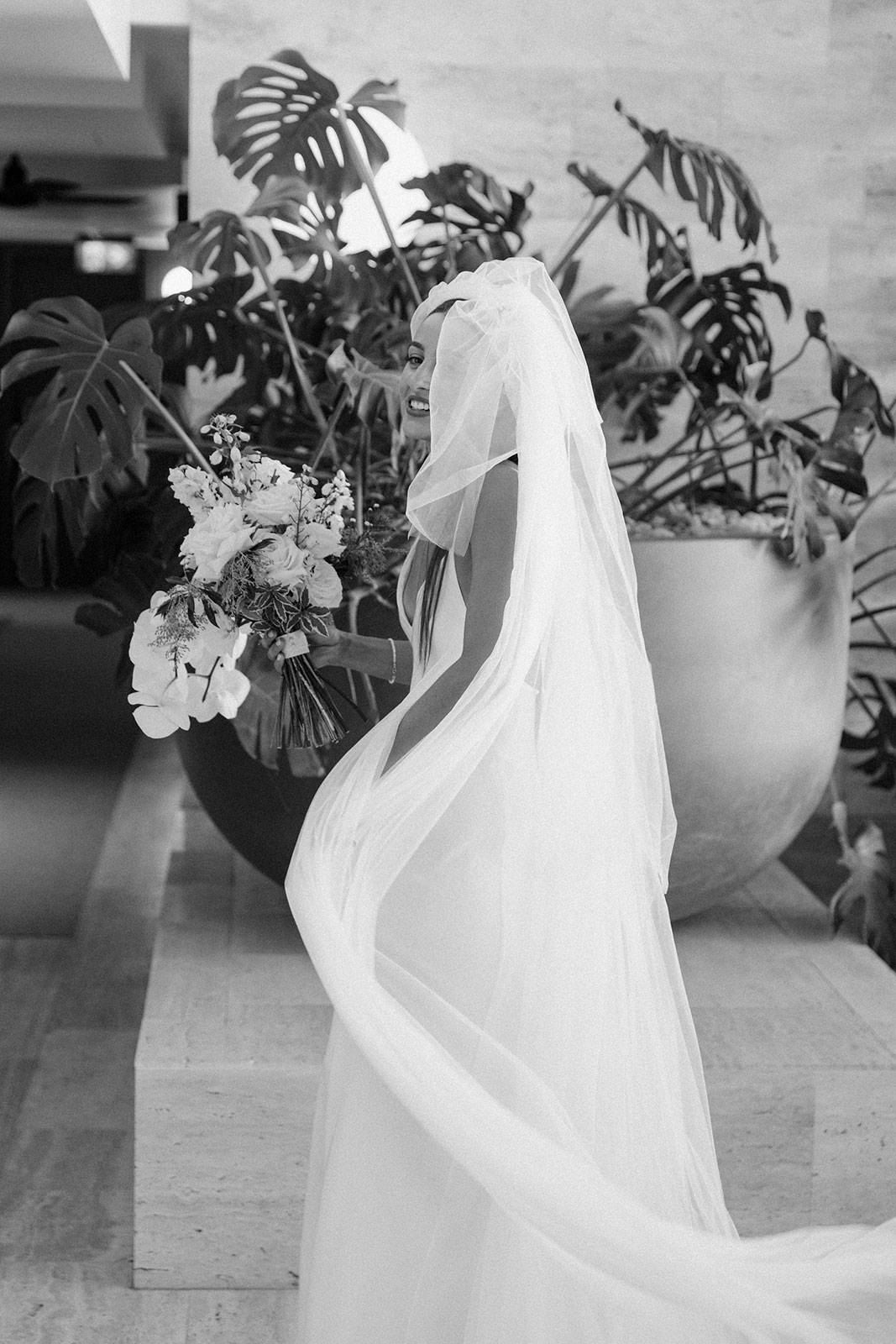 Bride smiling in wedding gown and veil