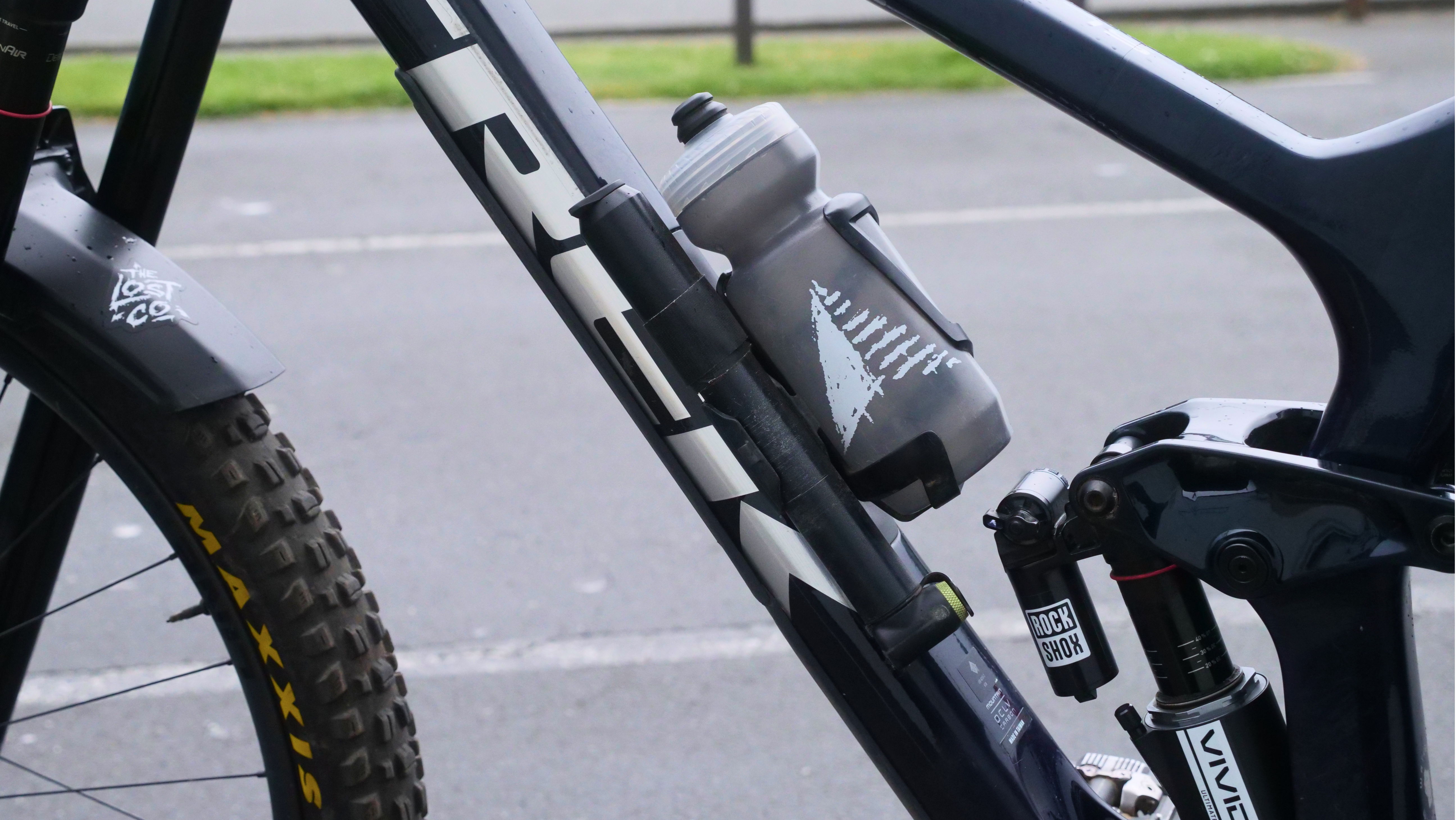 A close-up of a mountain bike frame with a water bottle holder.