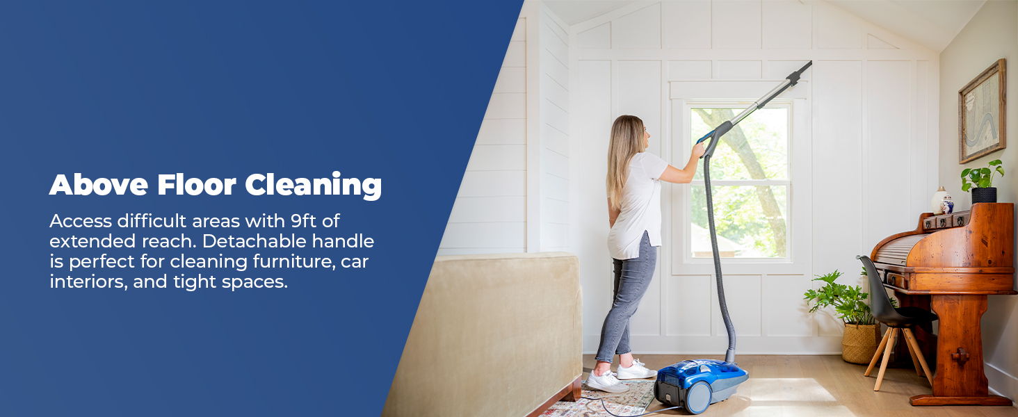 Woman using a cleaning machine for above floor cleaning in a bright room.