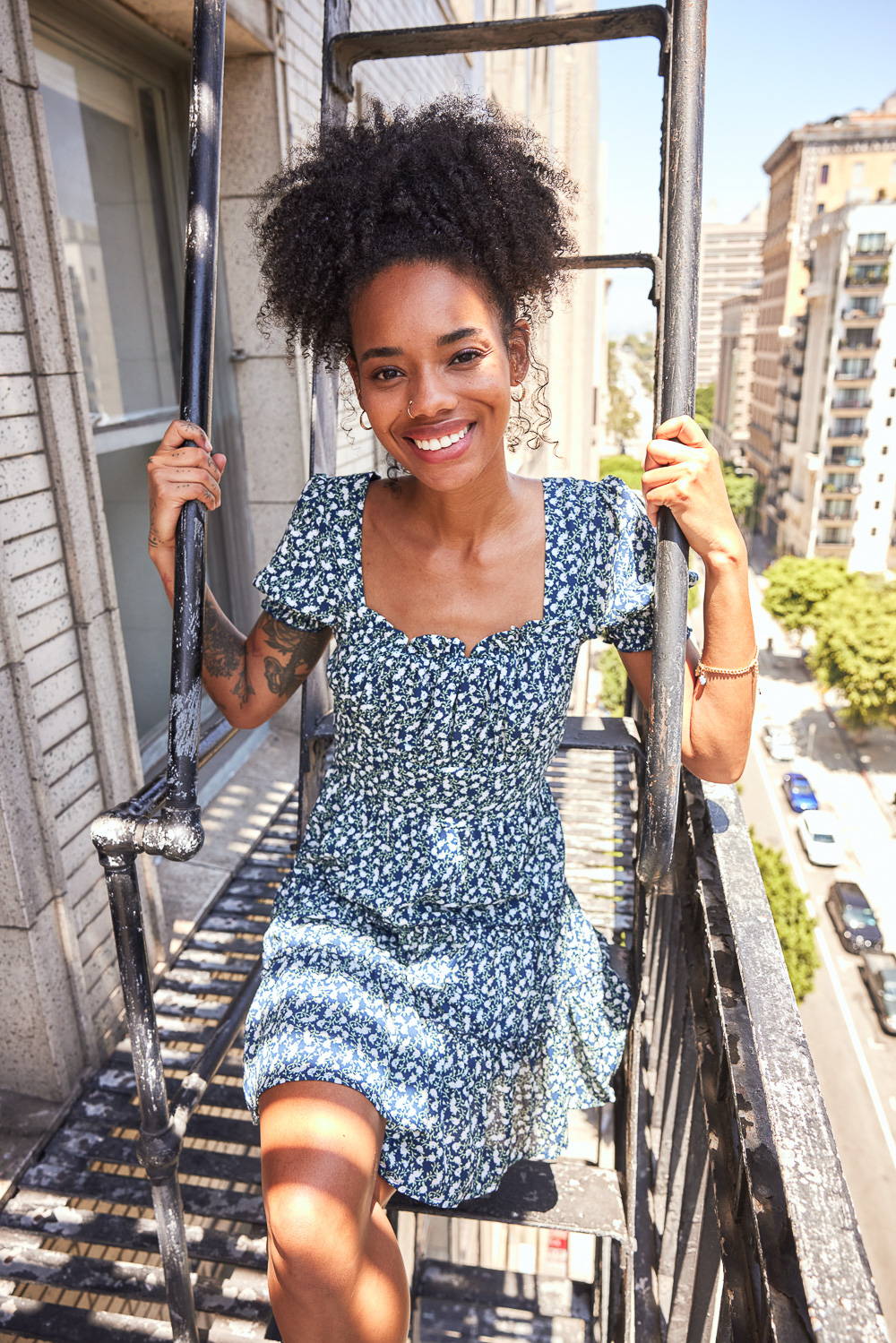 Trixxi Back to school embracing dorm life hanging out on the balcony in a navy with white flowers tier dress.