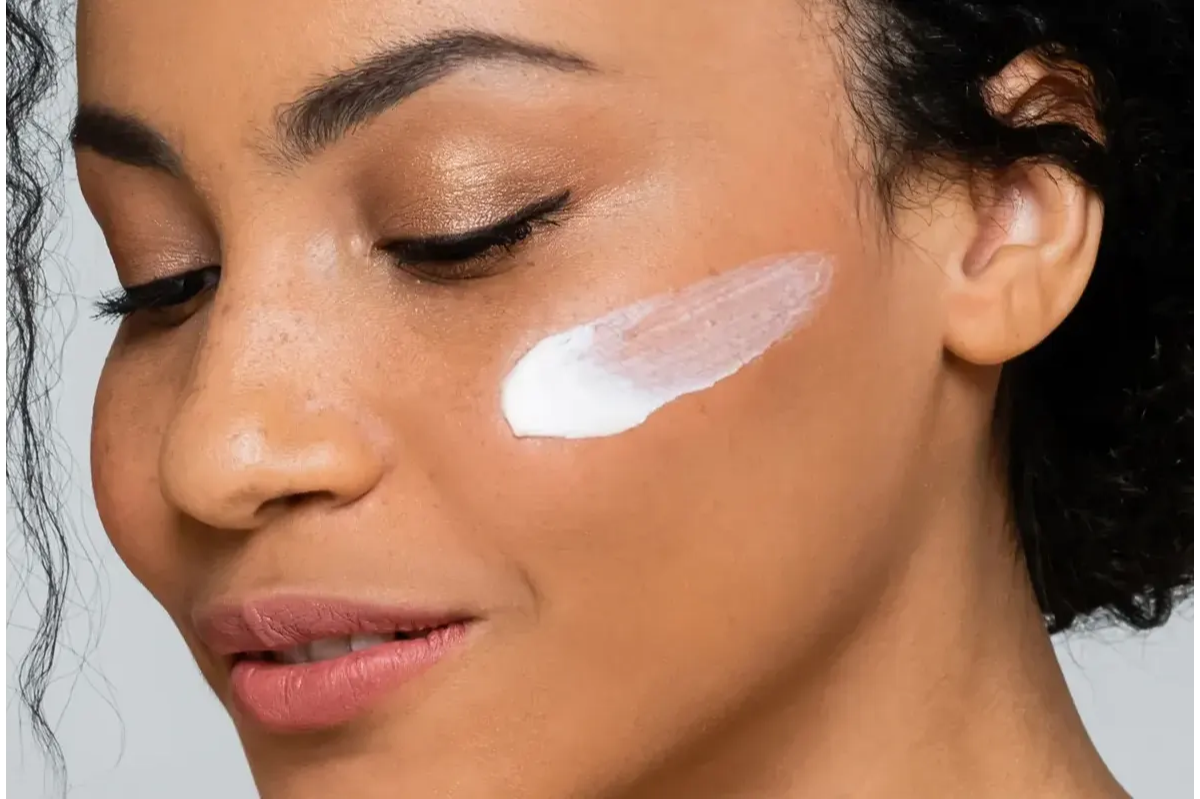 woman applying eye cream under the eyes