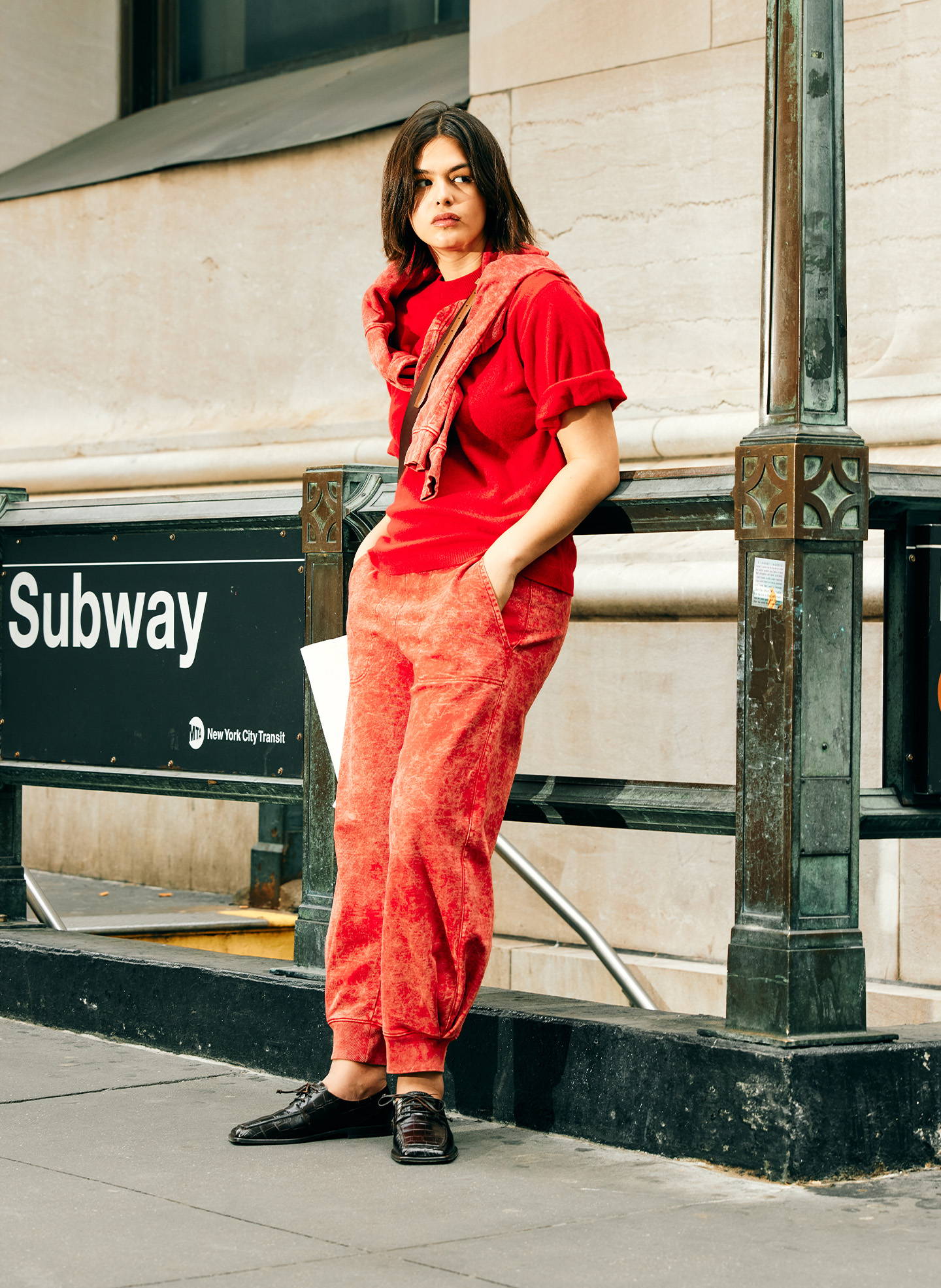 model standing in front of subway entrance