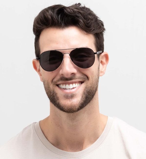 heart shaped face man wearing Leo sunglasses, metal aviator sunglasses, on a white background