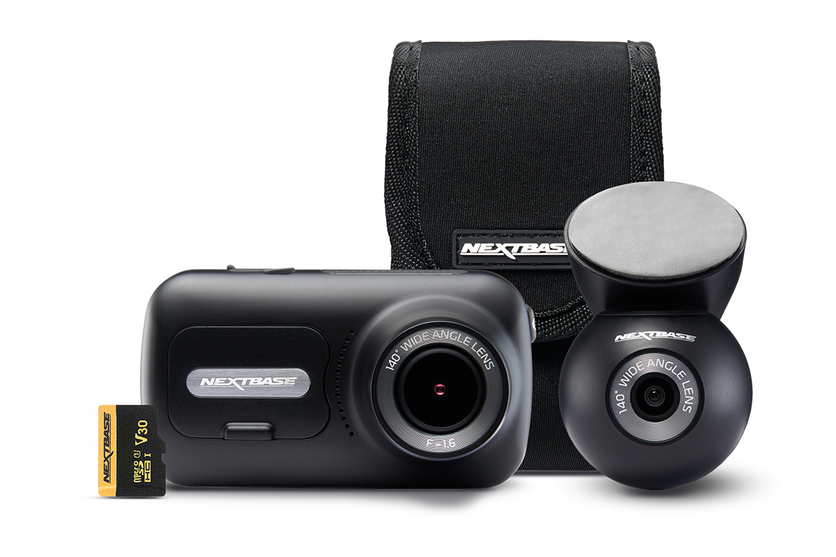 A camera, lens, and carrying case arranged together.