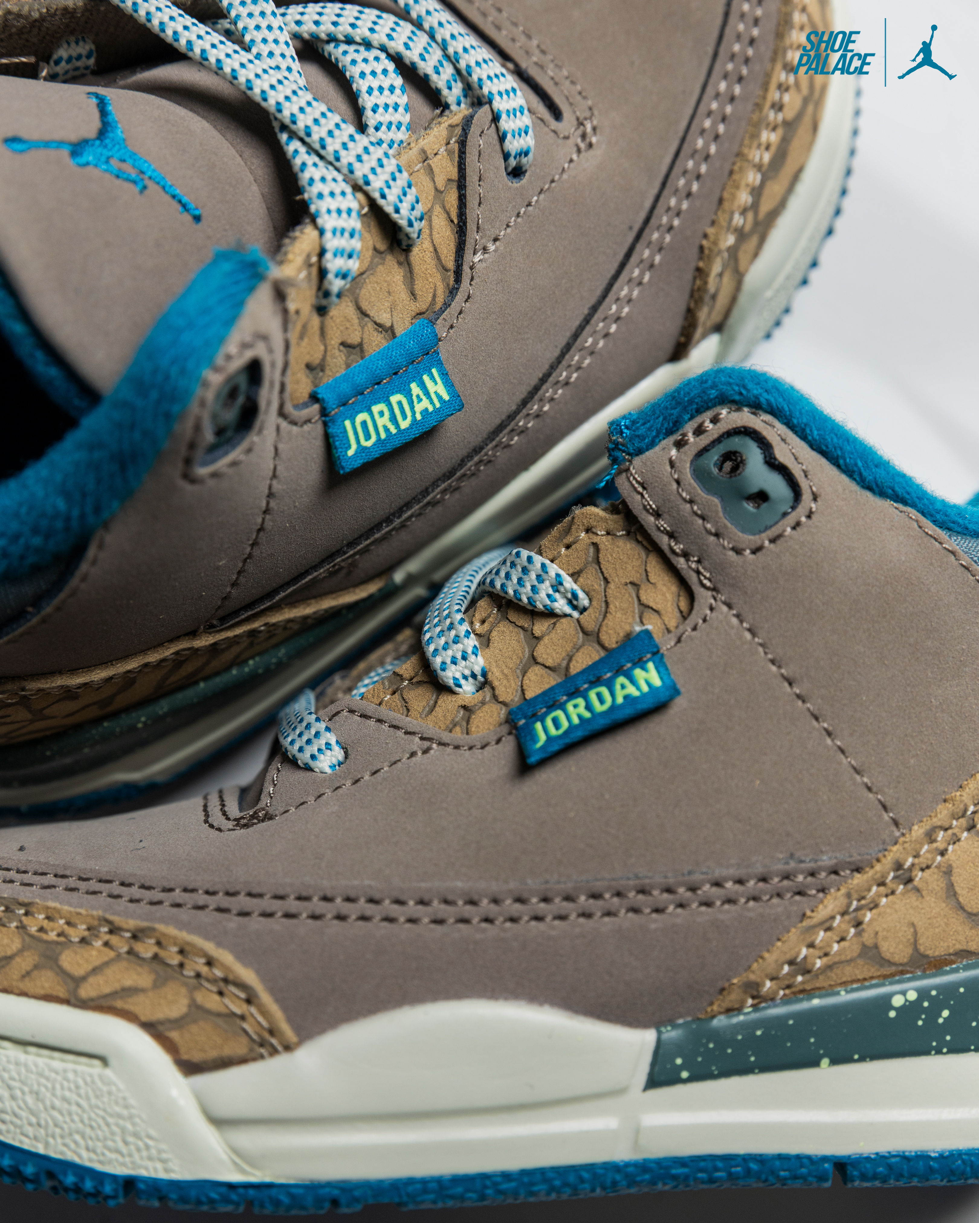 Air Jordan 3 Retro Olive Grey - Close-up of Jordan sneakers with blue accents and textured design.