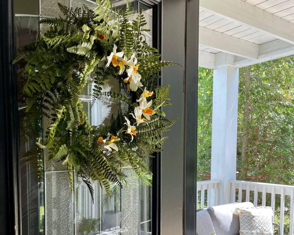 An artificial wreath from Nearly Natural hanging outside on a door entrance