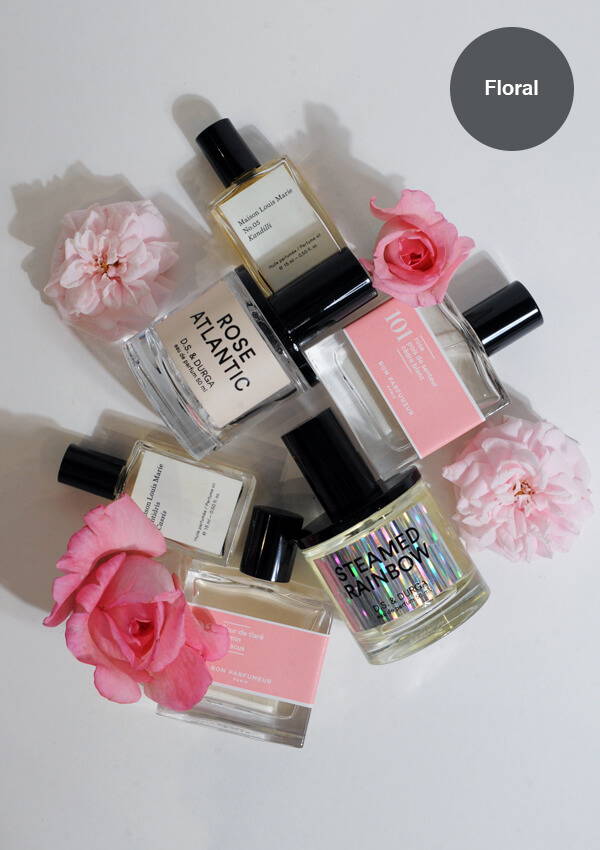 A styled flat lay image of multiple floral fragrances by D.S. & Durga, Maison Louis Marie and Bon Parfumeur amongst fresh roses.
