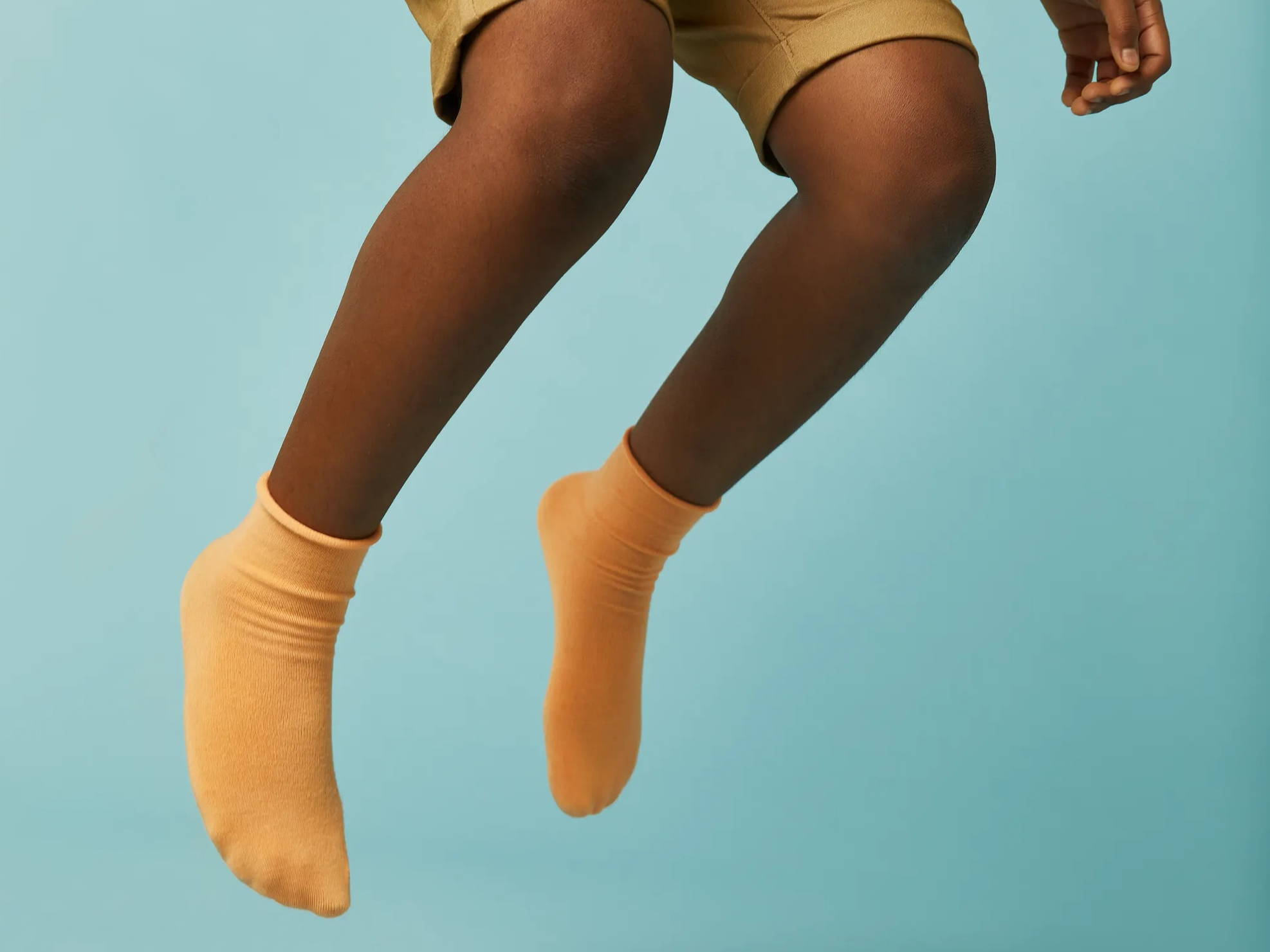 SmartKnitKIDS, boy with seamless socks, boy jumping wearing socks