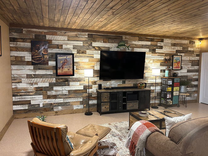 living space with two-toned wood accent wall and wood ceiling