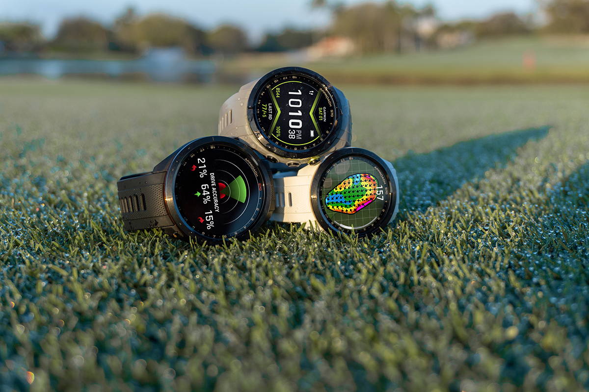  A pyramid of the Garmin Approach S70 golf GPS watches on a golf course—a gray 42 mm, white 42 mm, and black 47 mm