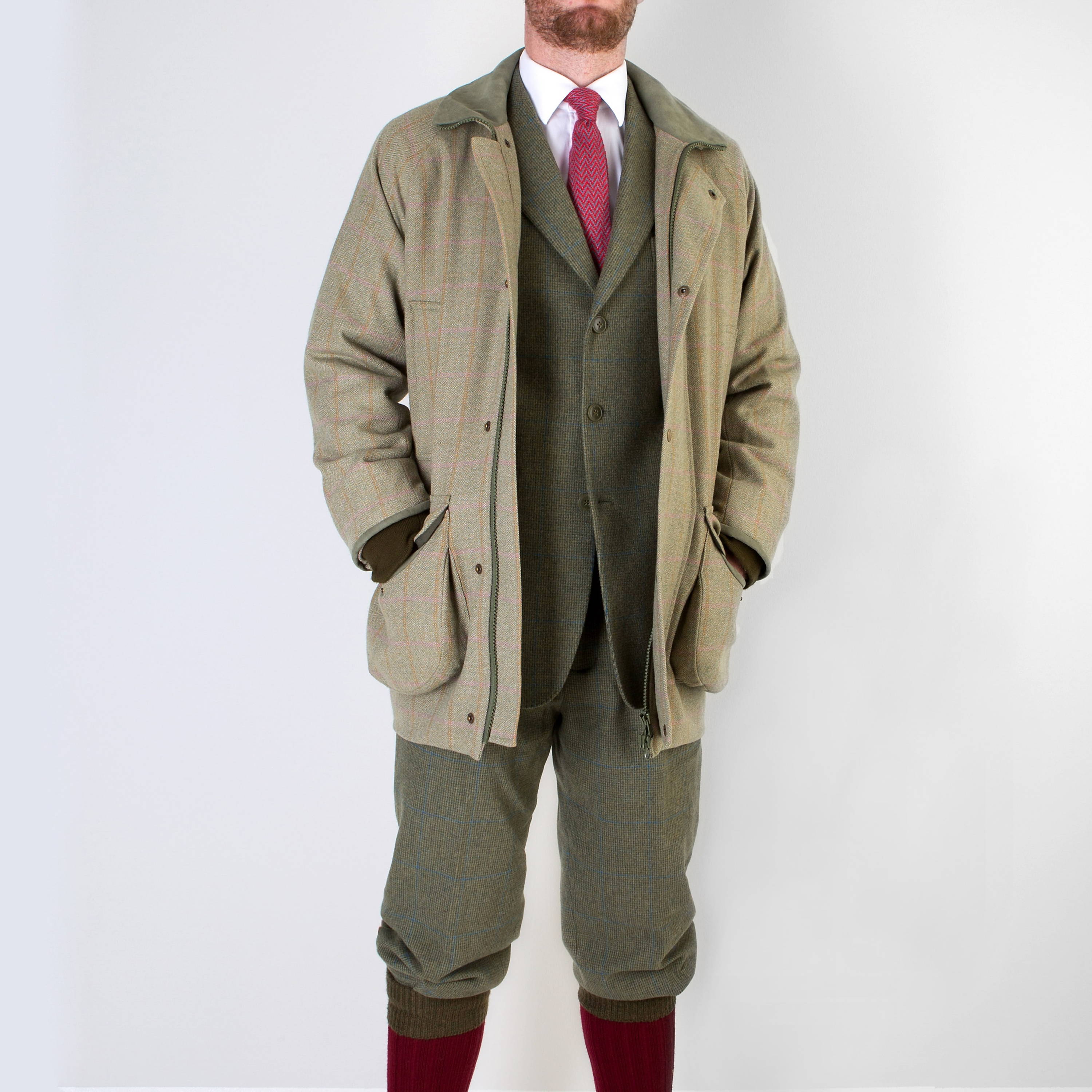 Man wearing shooting suit with field coat, breeks, plus 4s and tweed suit by Mullen and Mullen bespoke tailors