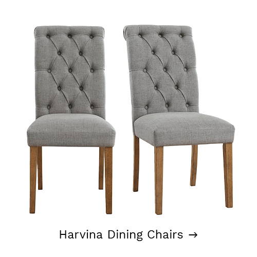High-backed dining chairs with button-tufted backs.