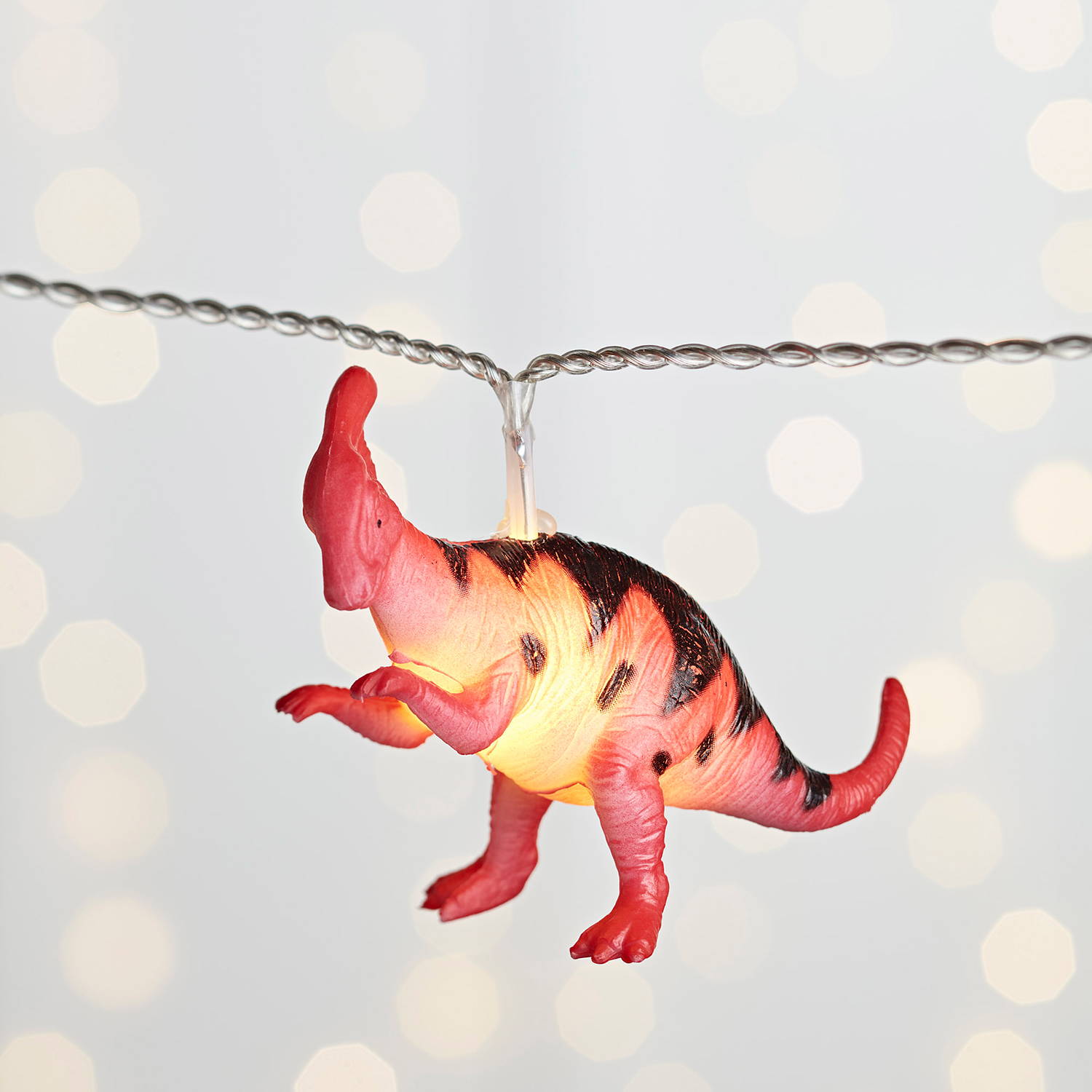 close up of multicoloured dinosaur fairy lights