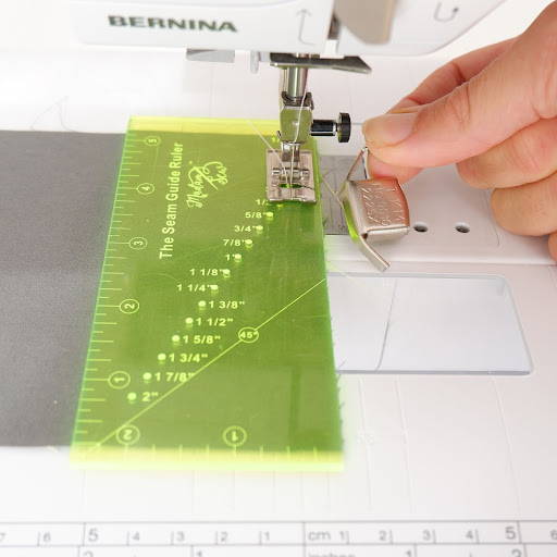 seam guide ruler and a seam guide on a sewing machine