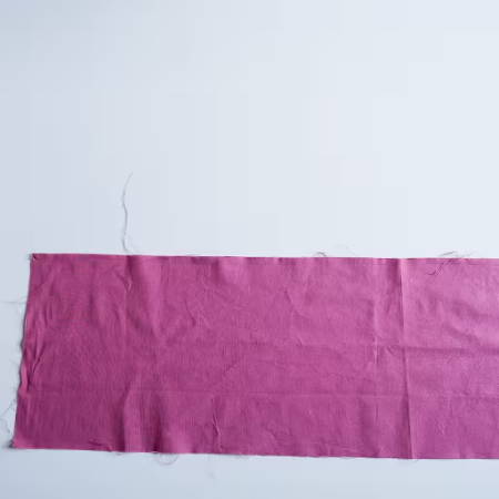 magenta fabric strip on a white table