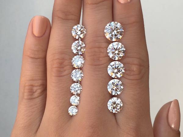 round diamonds of different sizes on a hand