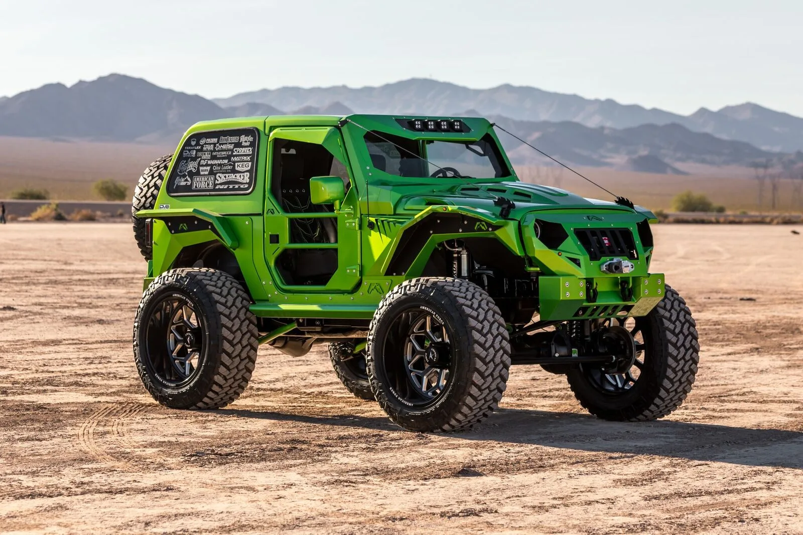 Front-three-quarter Cambered Customs 2012 Jeep Wrangler JK seven-slot grille round headlights custom Jeep build exterior Conductor's Special 244 Nightmare Edition train horn kit featured install photo 1