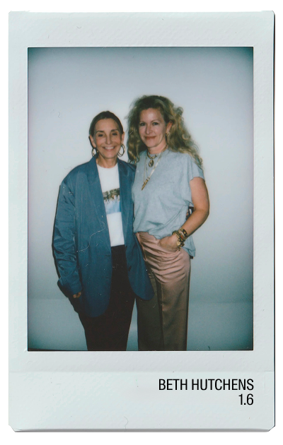 Two women posing together in a photo booth setting.
