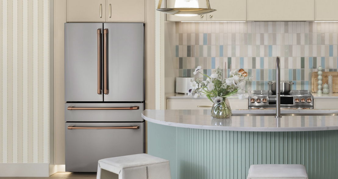Modern Cafe kitchen with stainless steel refrigerator, pastel tiles, and minimalist decor.