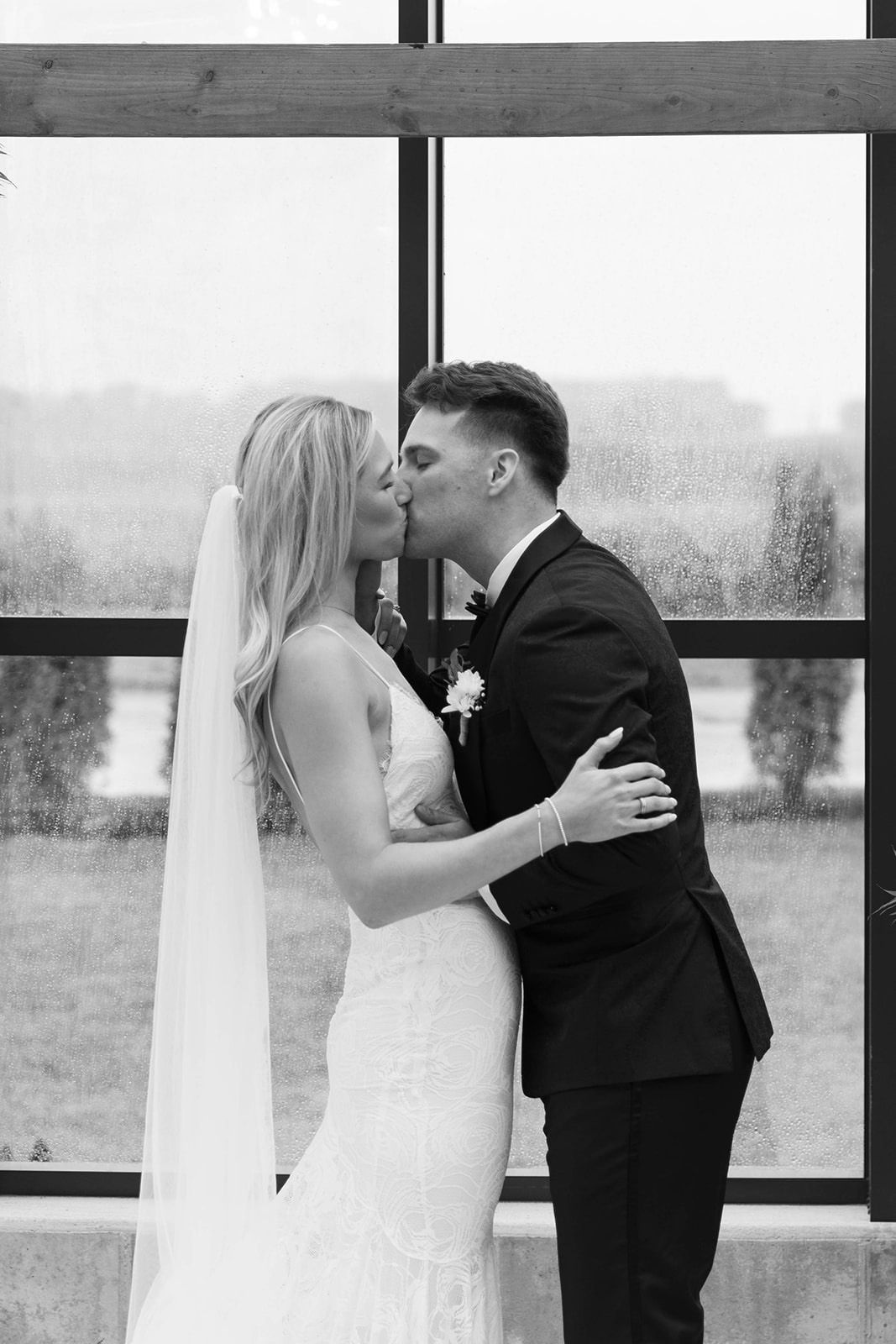 Bride and groom sharing a kiss in a modern venue.