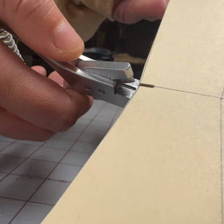 Using a pattern notcher on a pattern piece