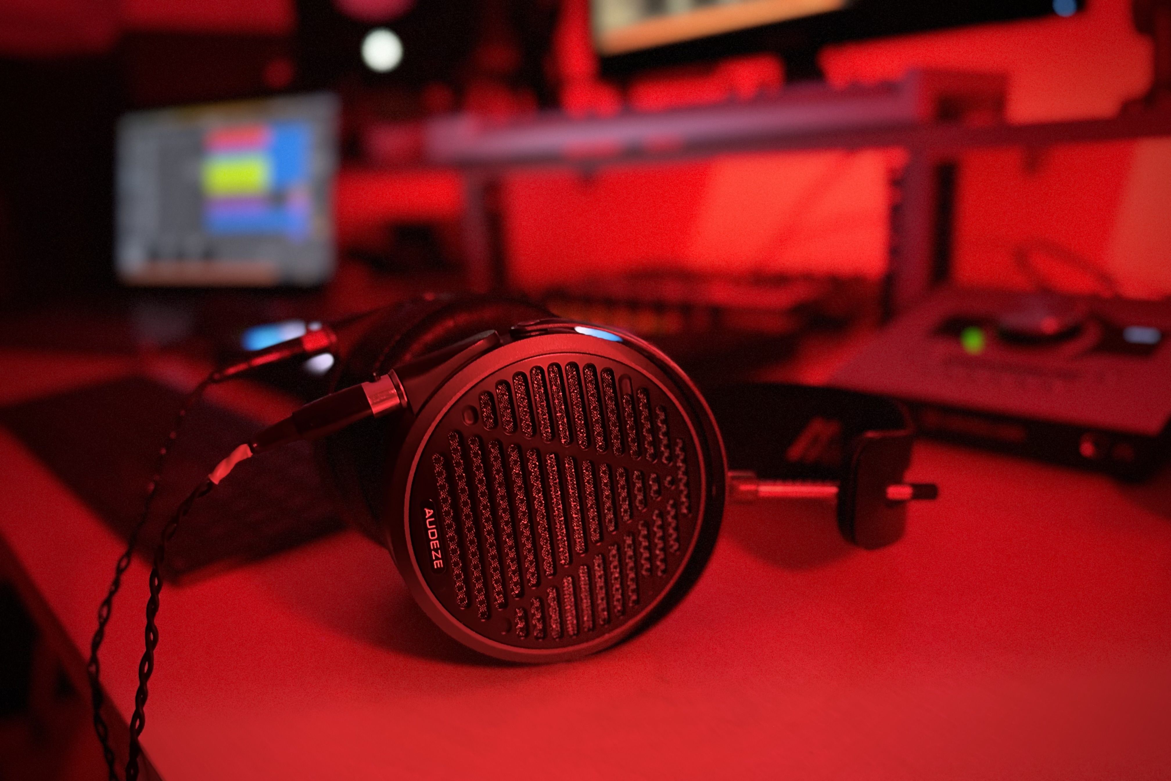 Audeze MM-500 headphones sitting on table in the studio with red lighting 