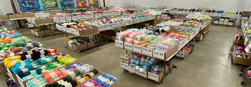 Herrschners Retail Store: image of Bargain Corner with clearance yarns stocked in bins