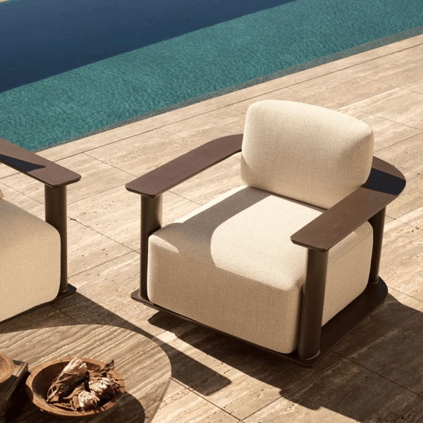 Newport aluminum outdoor lounge chair with performance cushions positioned beside a swimming pool