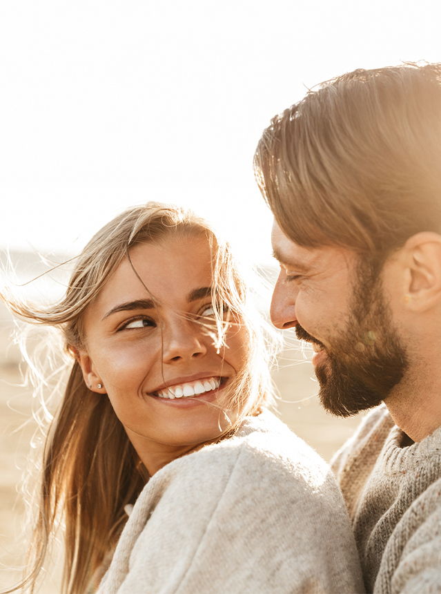 Man Kissing Woman With Pregnacare Logo