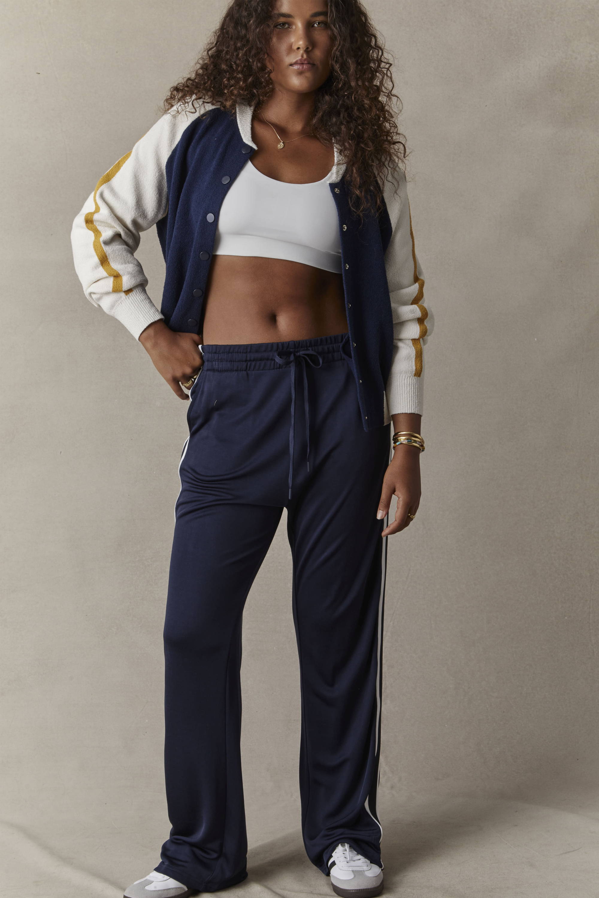 THE UPSIDE navy Celeste Pant worn with the navy Club Hallie Knit Bomber and white Peached Jade Bra.