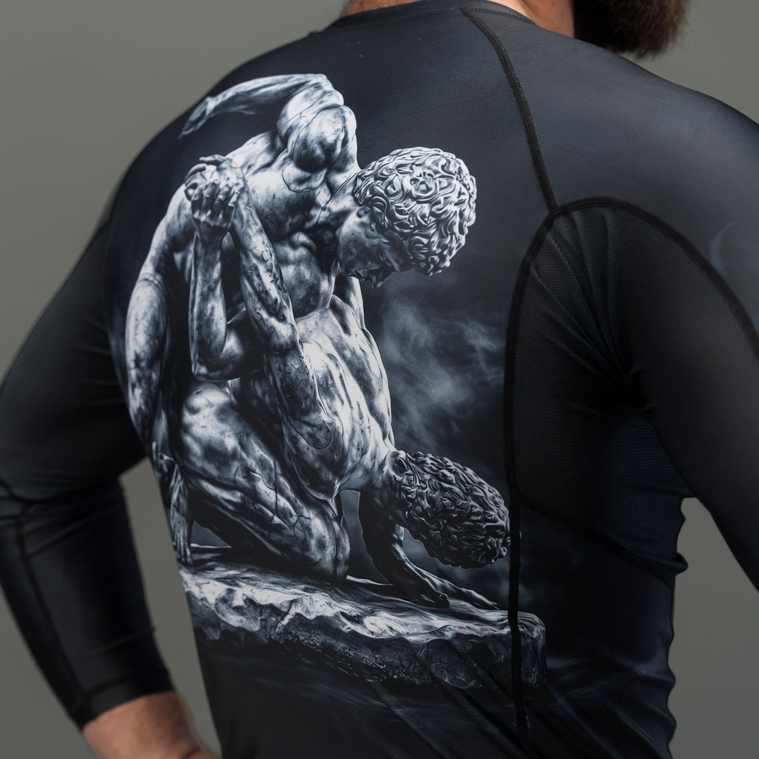 Athlete wearing a black shirt with a detailed artistic design on the back.