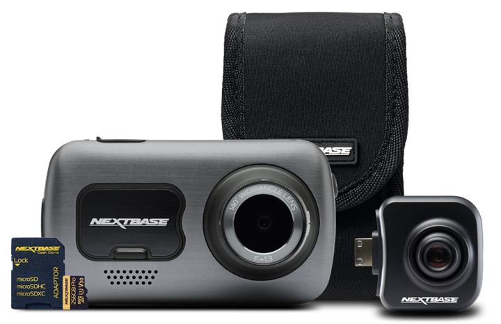 Camera with accessories including a memory card and a protective case.