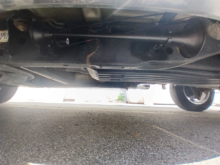 Underbody view of black air horn installation on Ford F-150