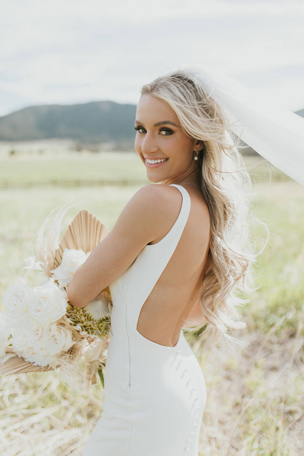 Bride wearing the martini gown and truly madly deeply long veil