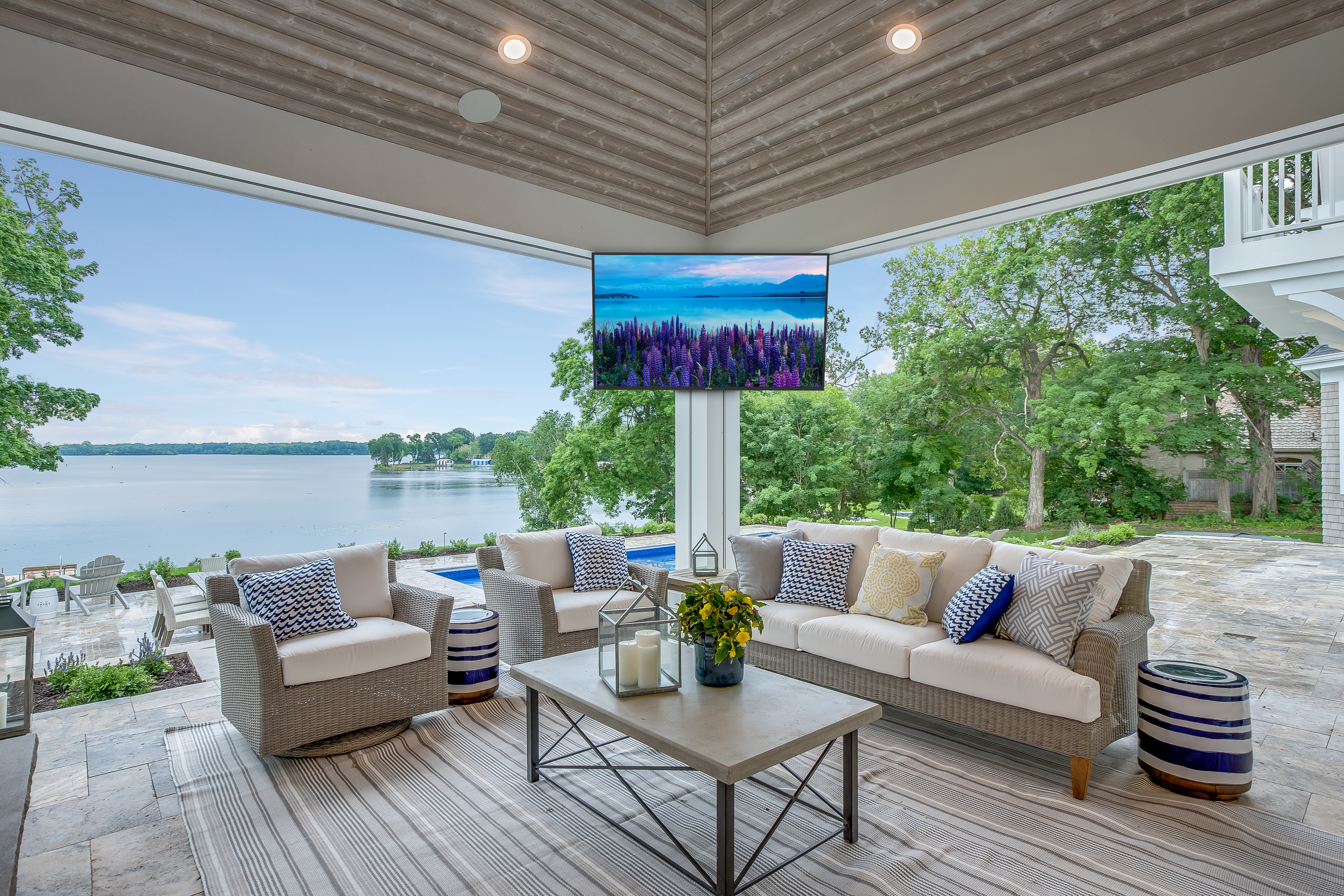 Modern outdoor living space with lake view and comfortable seating area.