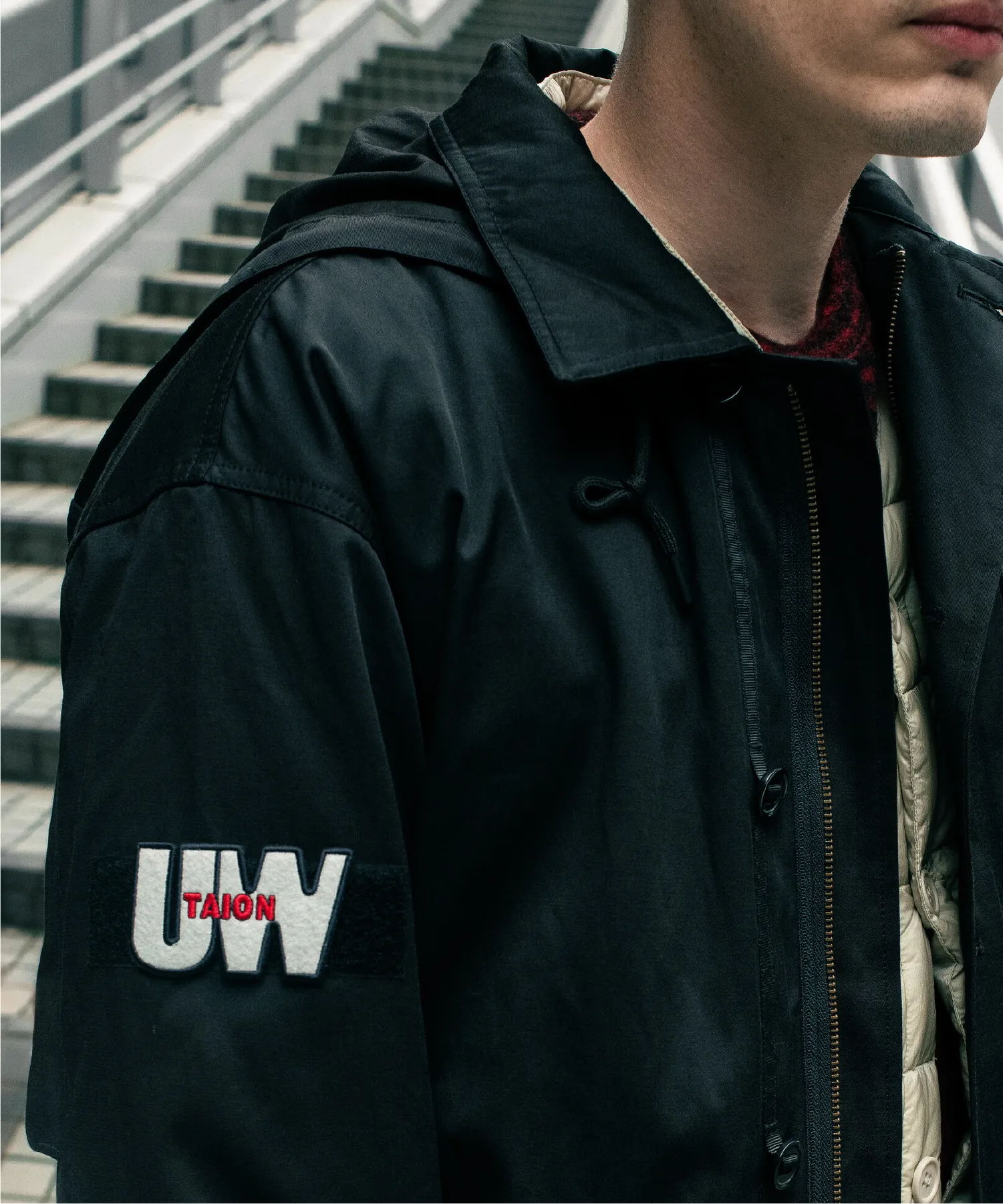 Person wearing a black jacket with 