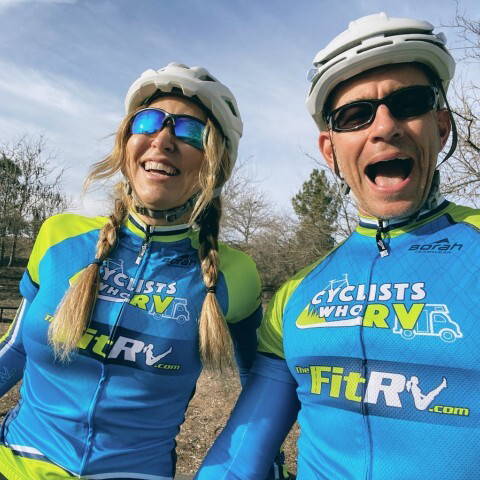 Portrait of Stefany and James in their cycling gear.