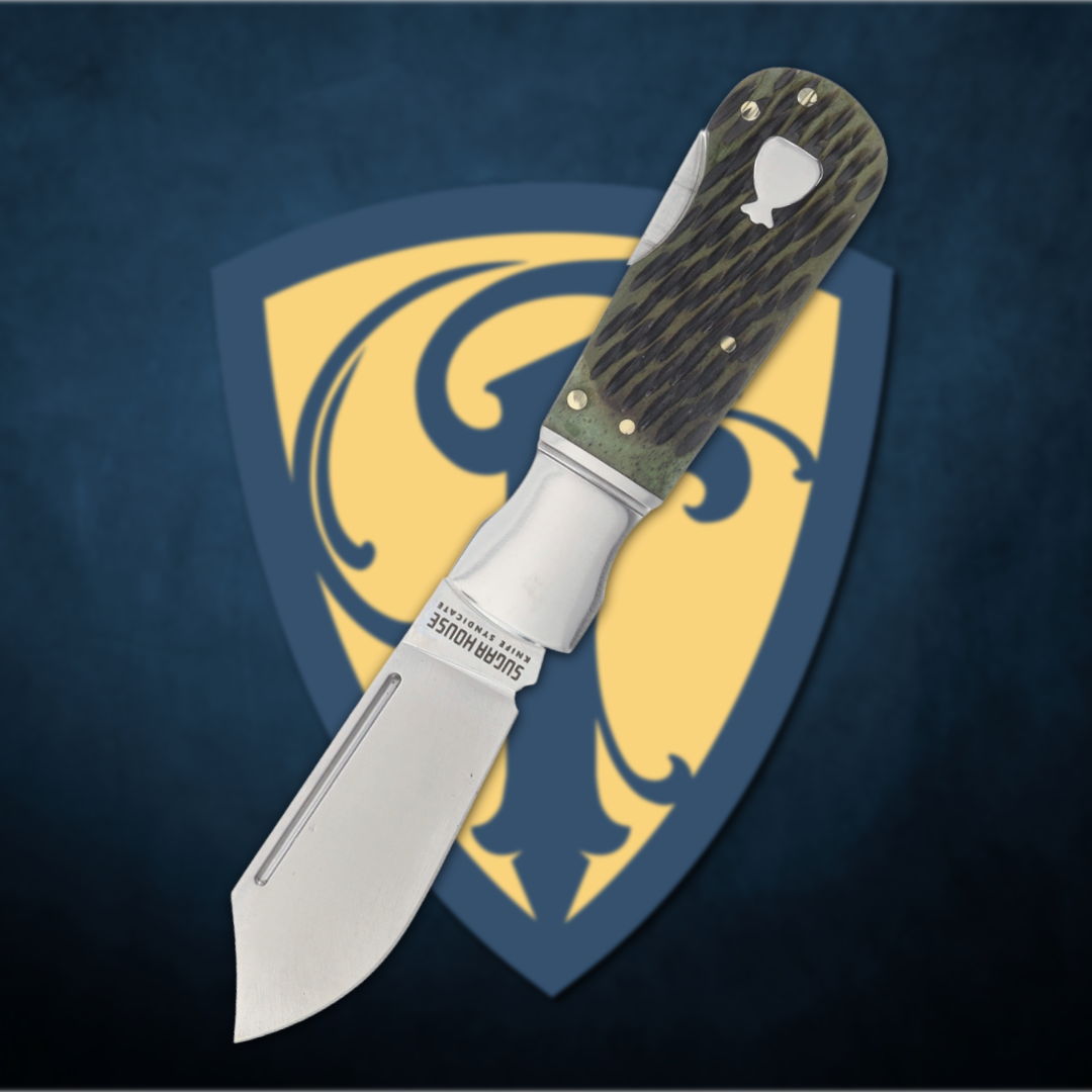 A folding knife on a decorative shield background.