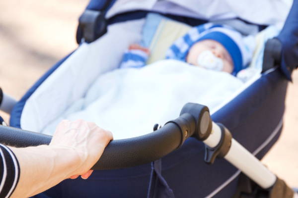 alone baby sleeping in stroller with pacifier