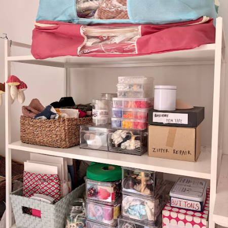 Open shelves with sewing supplies and tools