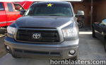 Front-facing dark gray Cody's 2010 Toyota Tundra pickup black mesh grille chrome Toyota emblem fog lights concrete driveway HornBlasters Shocker XL train horn featured customer install gallery photo 1