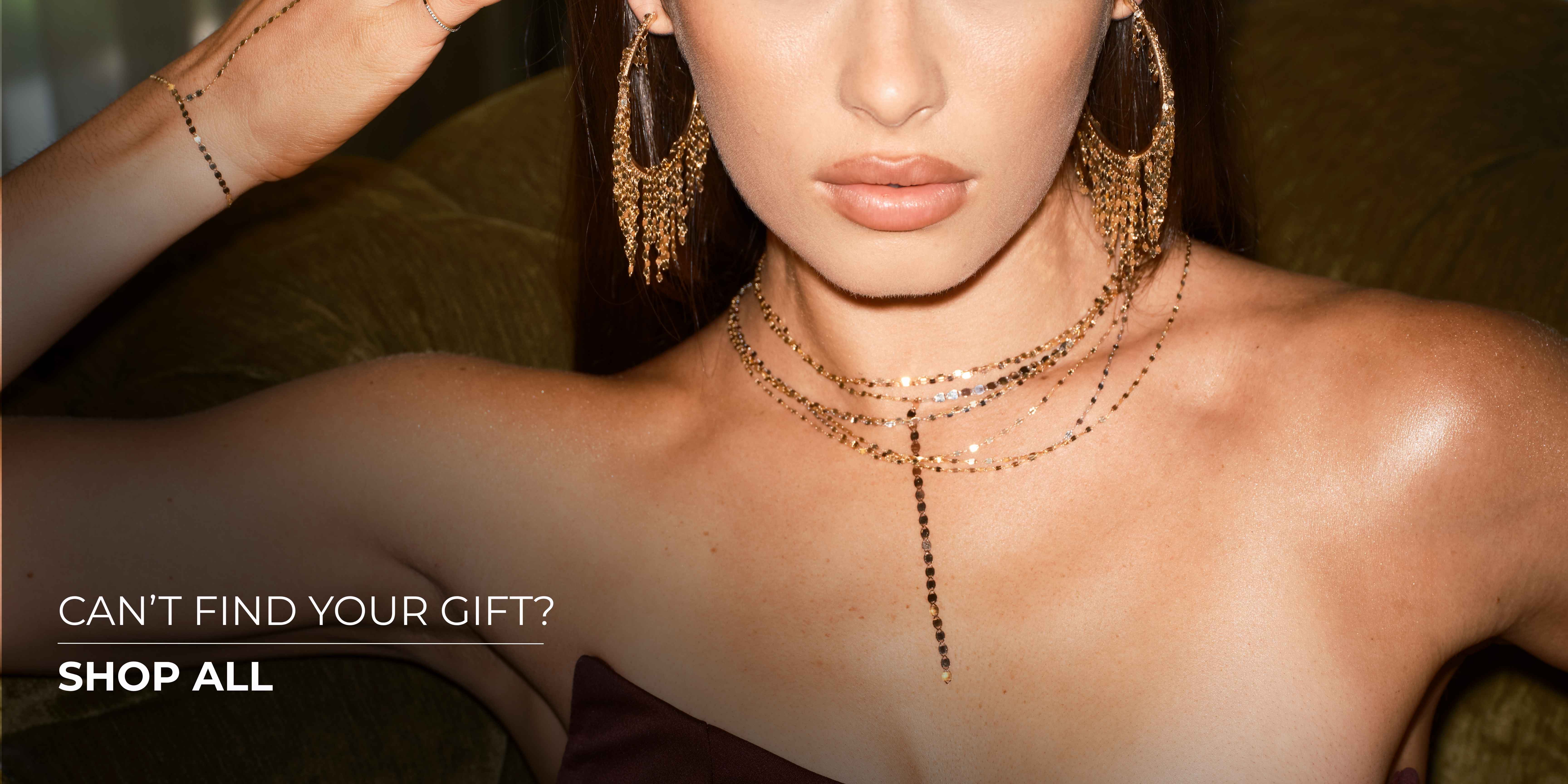 Woman posing with jewelry, promoting gift options.
