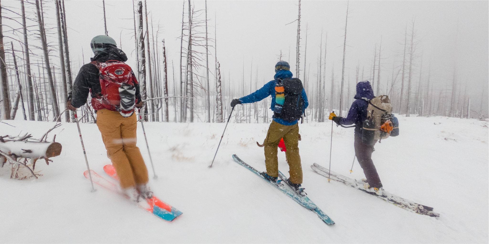 Three skiers in Mt. Hood with backpacks and Rumpl blankets