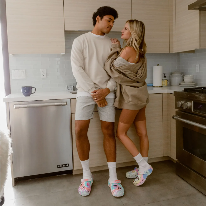 man and woman in kitchen wearing crocs