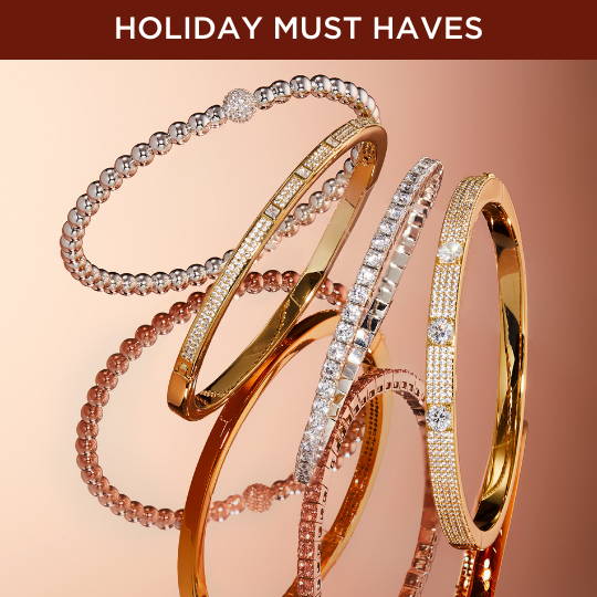 Click to shop Holiday Must Haves. Image of gold bangle bracelets.