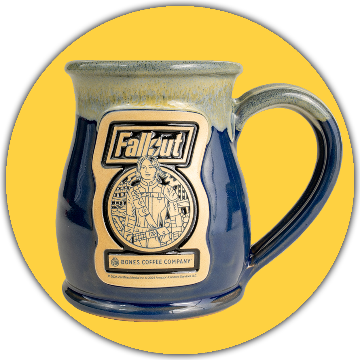 The front of the Bones Coffee Company Lucy hand thrown mug with the Atomic Apple art on the golden medallion. It is inspired by Zenimax and Amazon’s Fallout show. The mug is powder blue colored with a white and yellow glaze on top. A yellow circle is behind it.