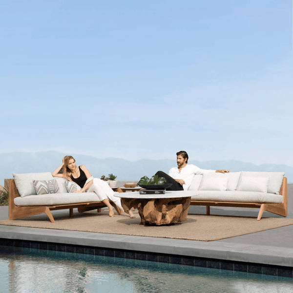 leek MLB 2-Seat Armless Sofa with a teak wood frame, white cushions, and a modern design, styled poolside on a patio with a mountain view backdrop, perfect for minimalist outdoor seating.