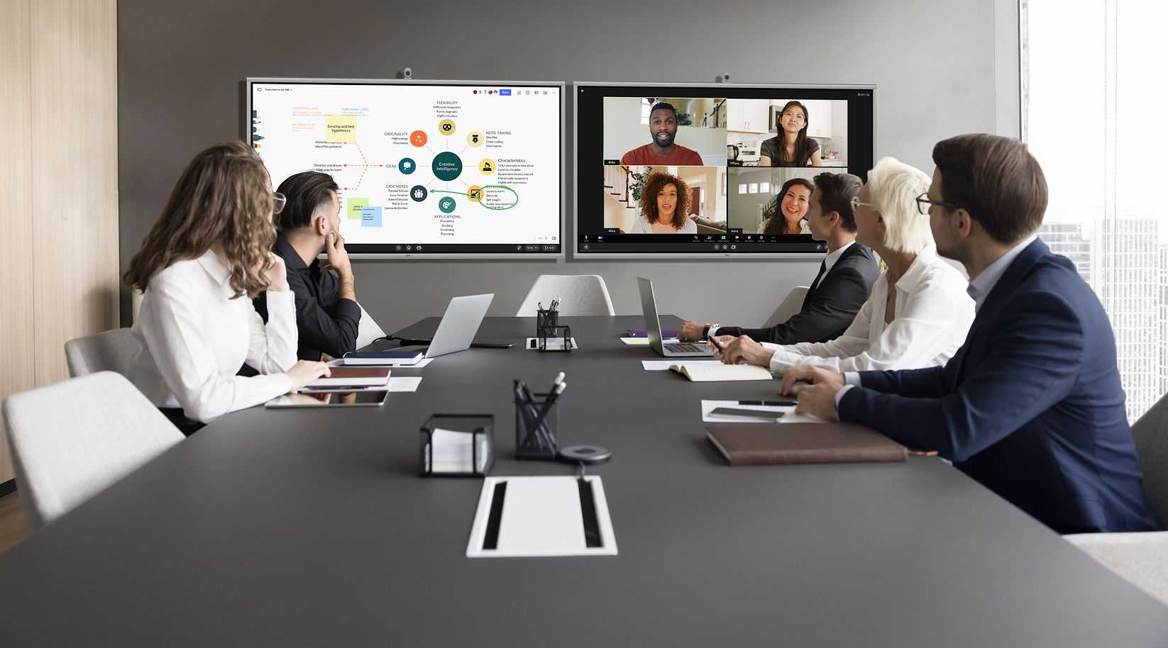 Group video conference in a modern meeting room with multiple participants.
