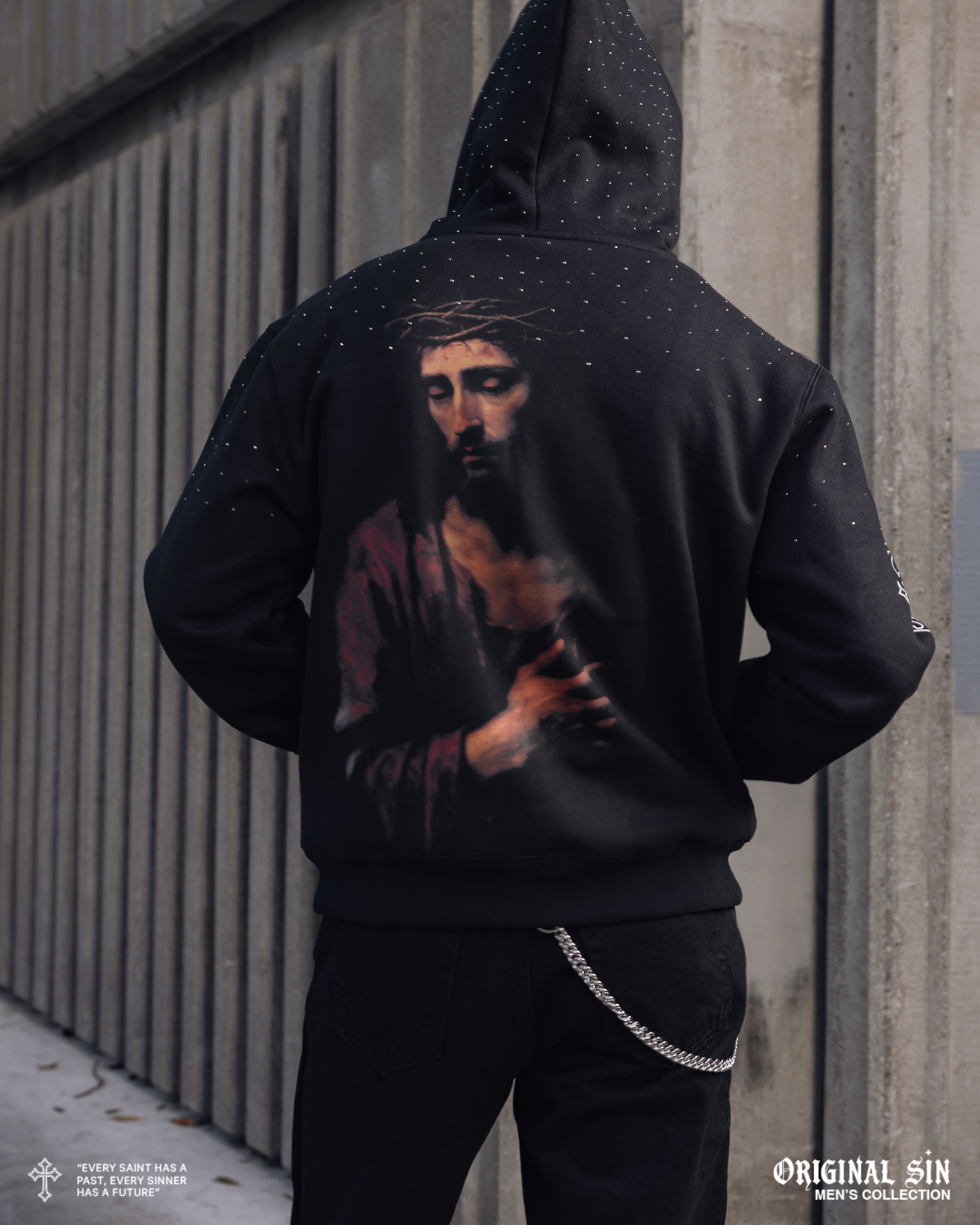 Person wearing a hoodie with a religious image on the back.