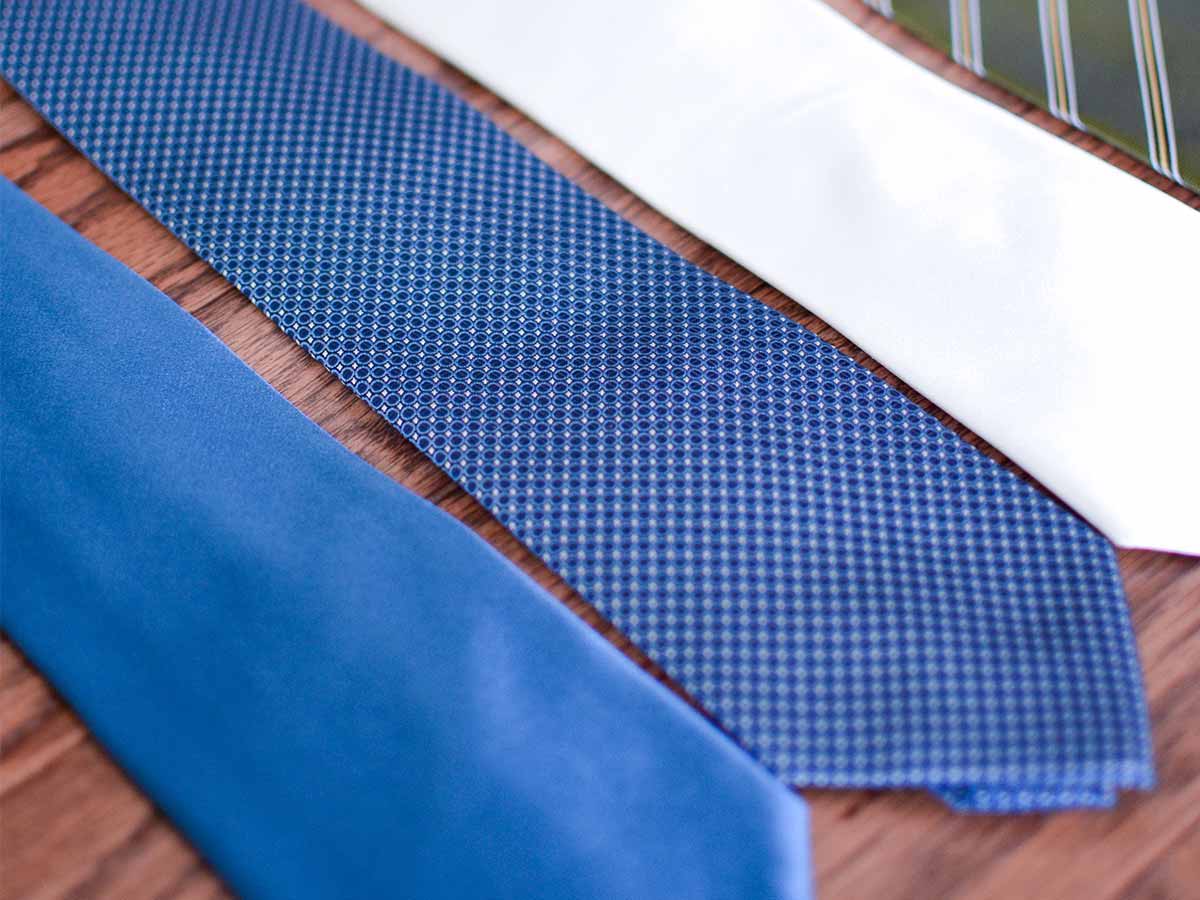 Variety of everyday ties on a wood background